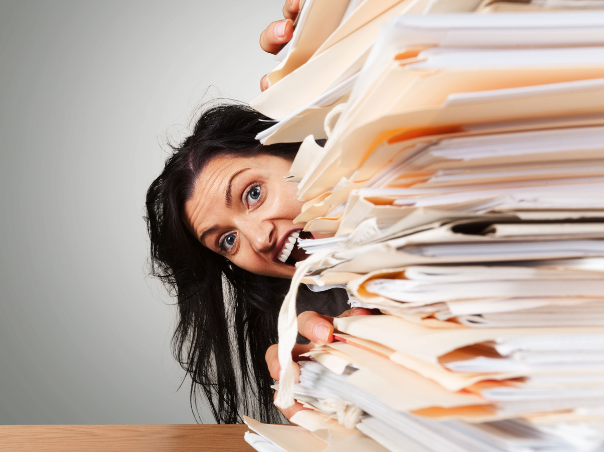 Office Worker Behind the Stack of Papers